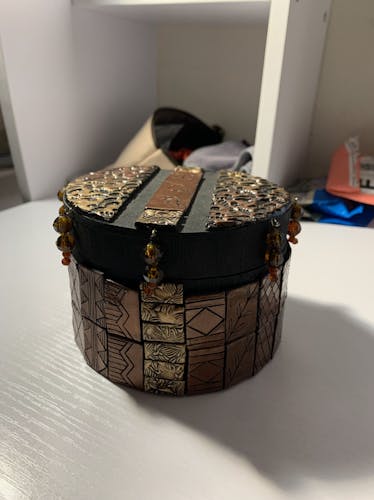 Black cylindrical box with red and gold clay tiles, red beaded trim, traditional Filipino script on lid “Kaibigan”, black inside with red glass mosaic