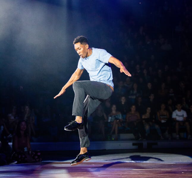 A man dancing on stage.