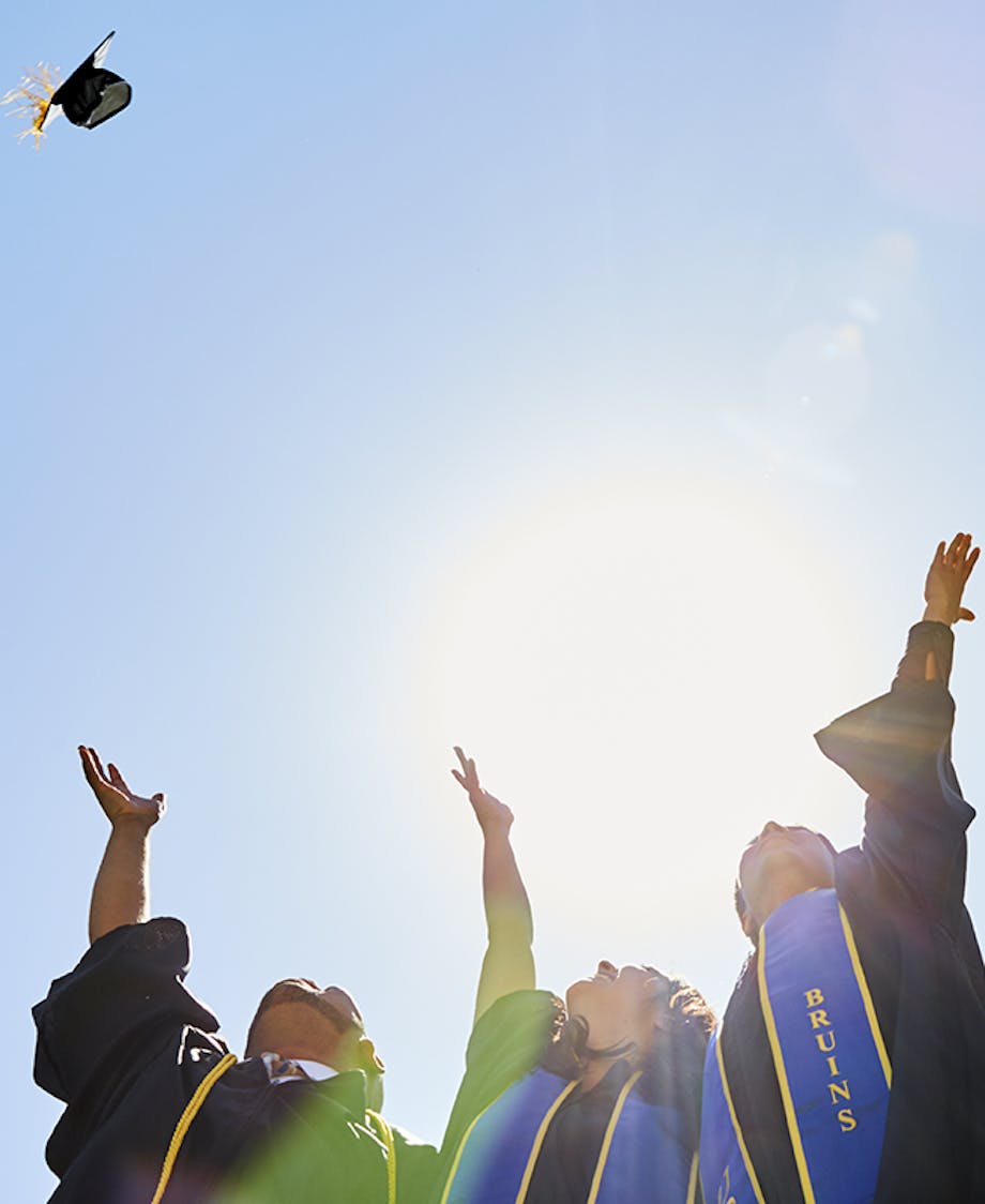 graduating students throwing their graduation hats