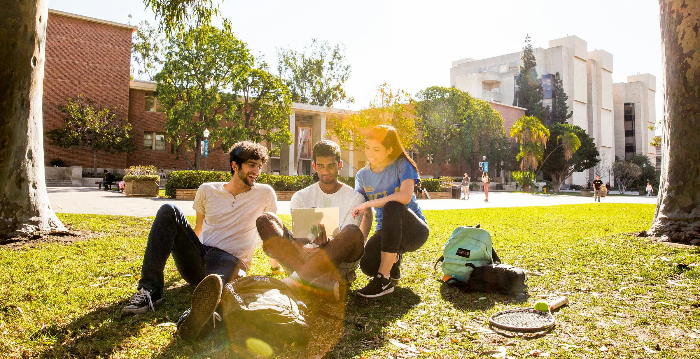 Students hanging out outside a campus building 