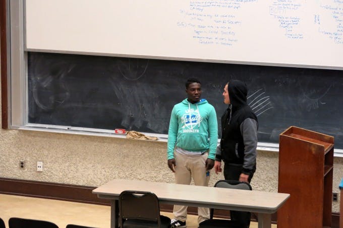 Noelberto Hernandez, a fourth-year UCLA undergrad majoring in sociology (at right), encourages a young visitor from OneWay Outreach to seriously consider a college education.