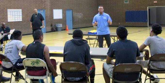 Ebreon Farris (’11, B.A., Sociology; standing, in blue shirt), a site coordinator from UCLA’s Early Academic Outreach Program, was a featured speaker at one of OneWay’s weekly meetings in January.