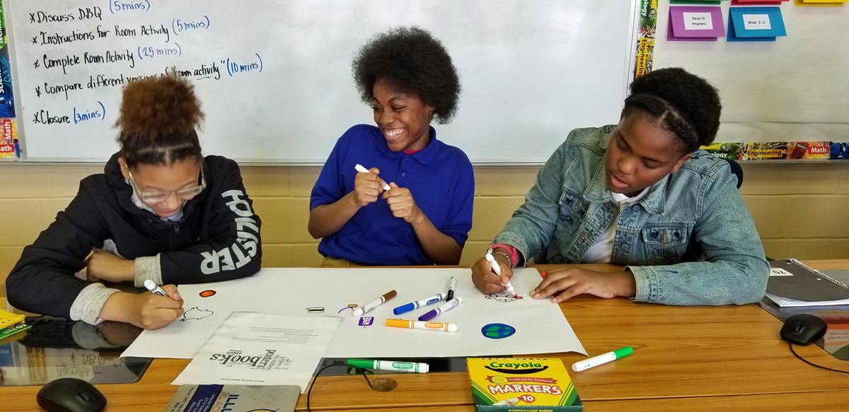 Students in Mississippi sketch out plans for a website.