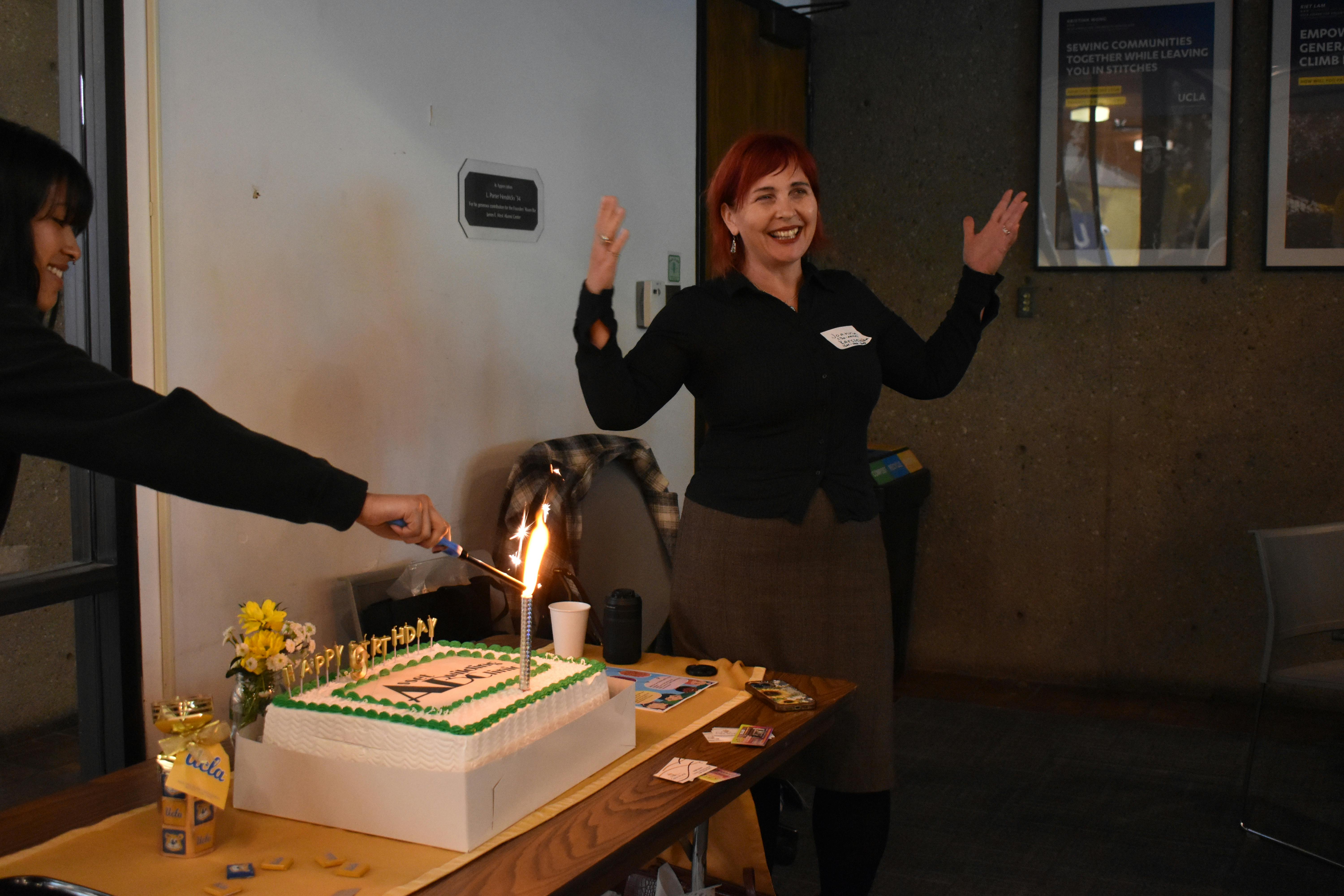 Dr. Karczewska, Founding Member of Asset Building Clinic, celebrates its 9th anniversary with cake. 