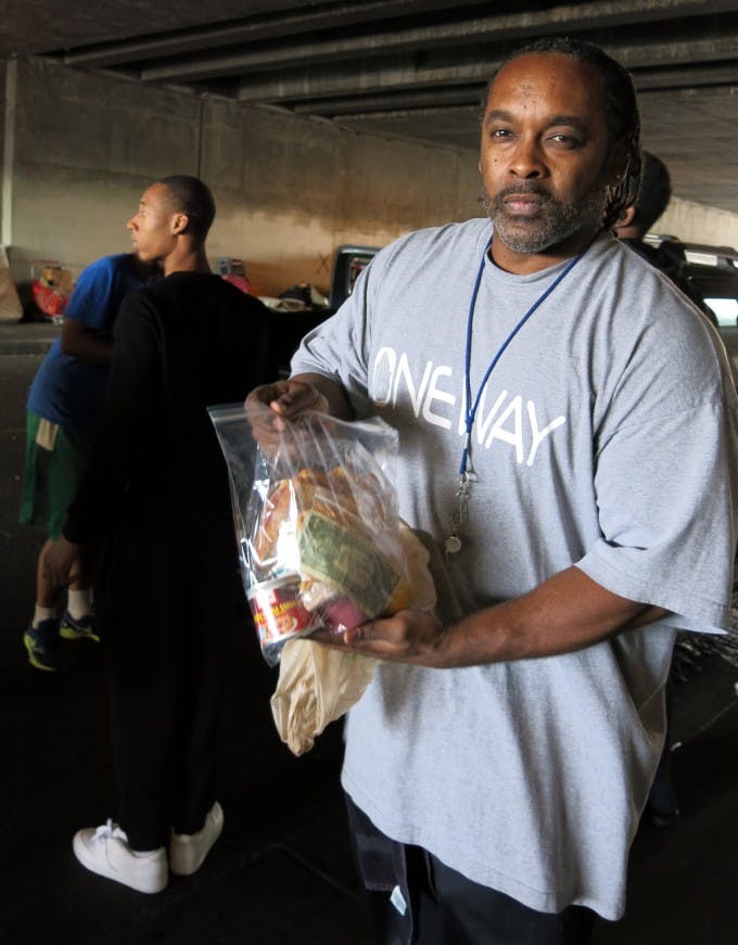 Travon Williams, founder of OneWay Outreach and the young African American men that he and his colleagues mentor, feed the homeless in their Immediate community in South LA.