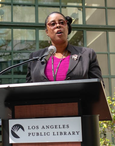 Jené D. Brown speaking LAPL podium 