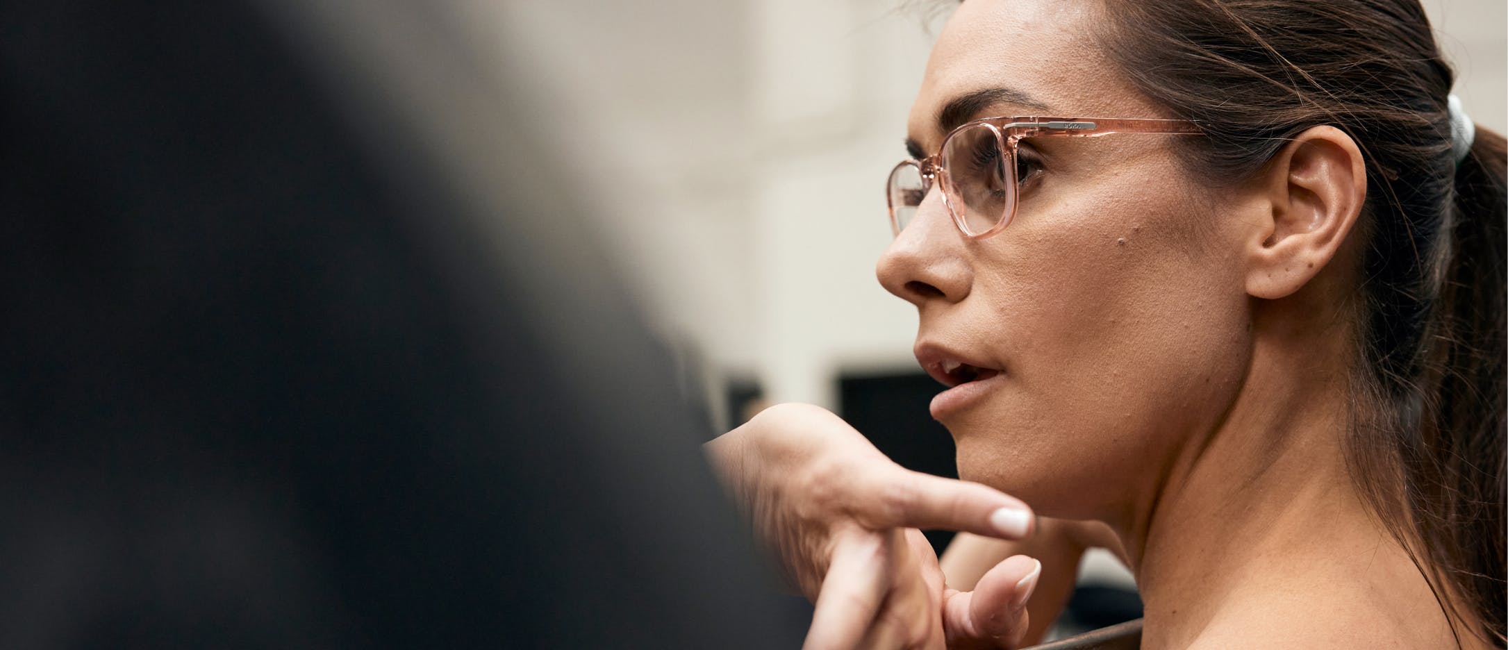 Woman weight training wearing ROKA eyeglasses.