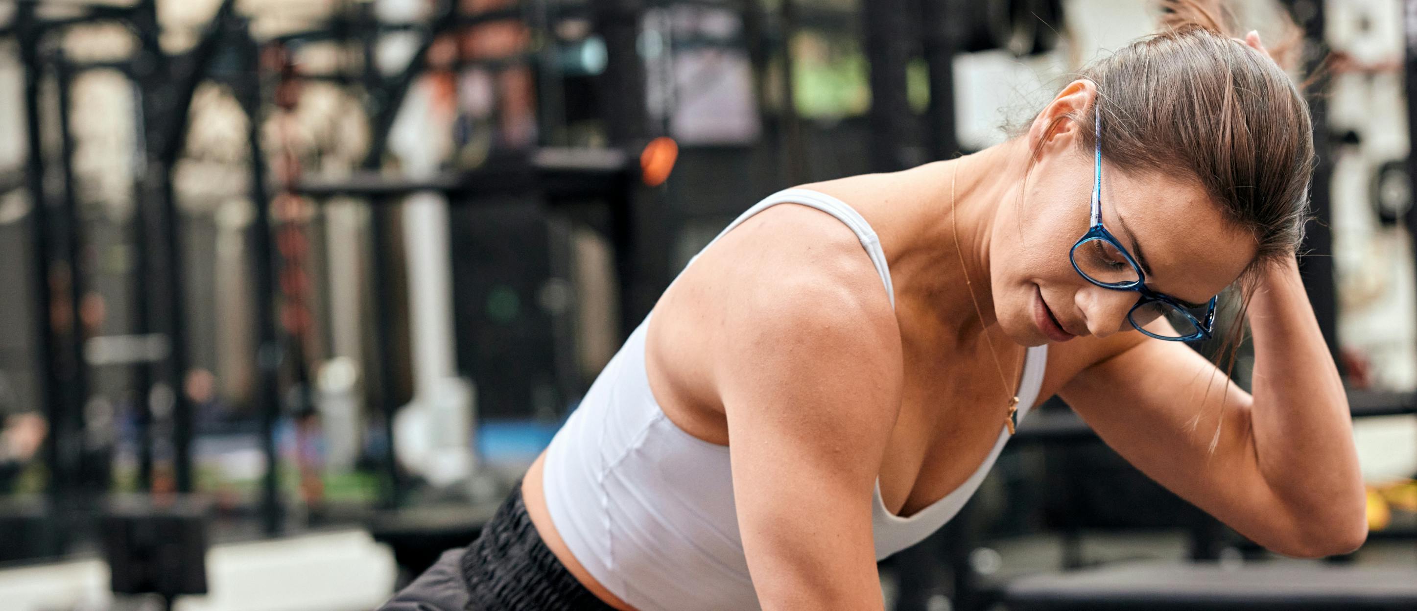 Woman weight training wearing ROKA eyeglasses