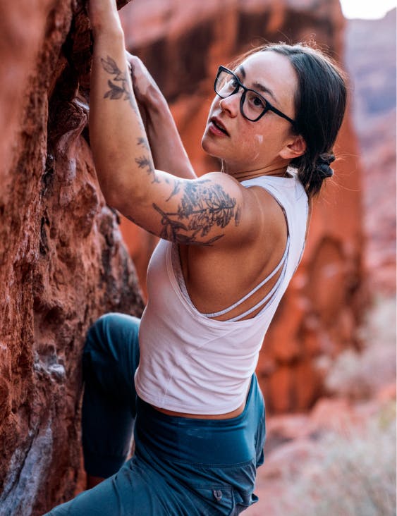 Woman rock climbing wearing ROKA eyeglasses