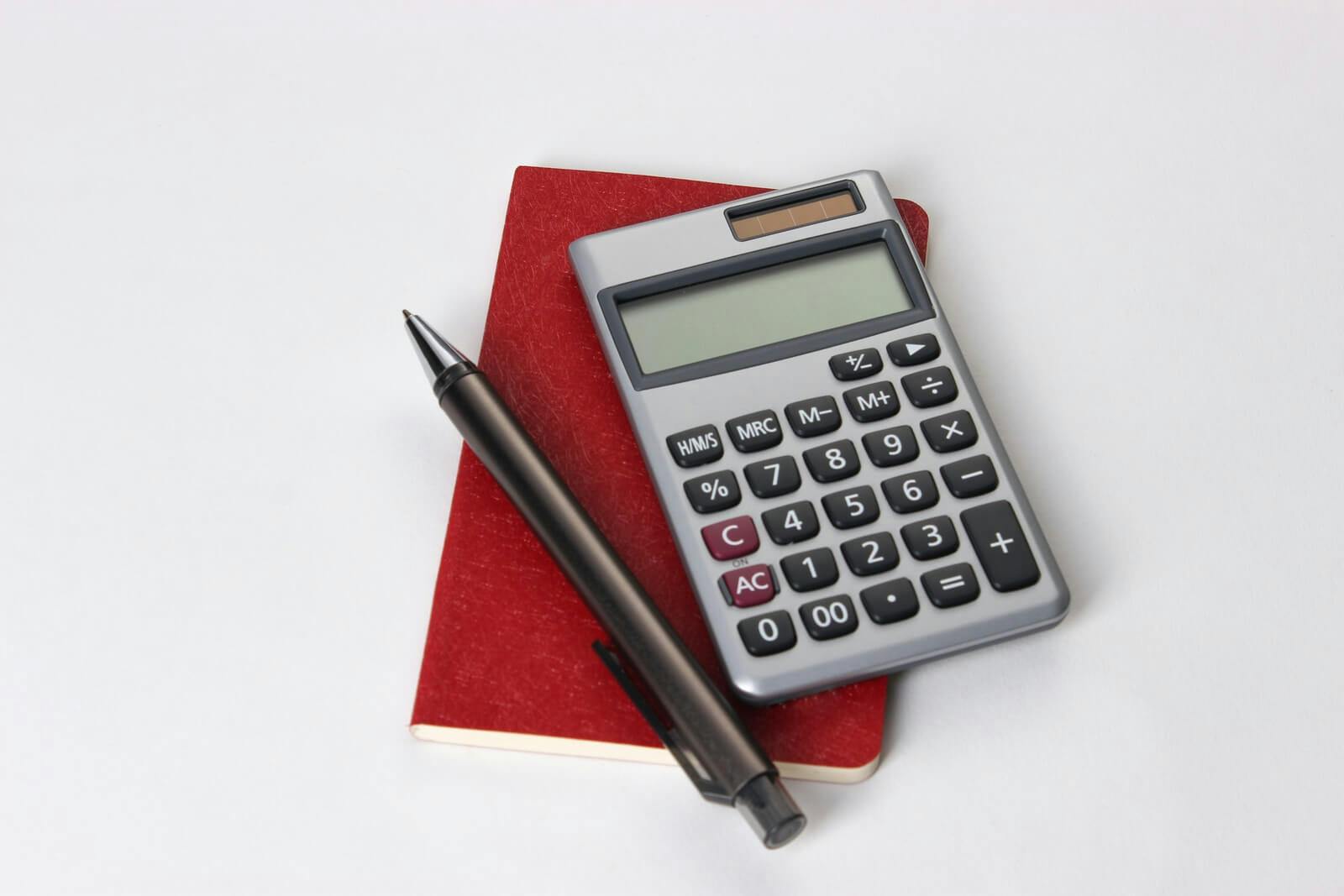 calculator, pen and notebook