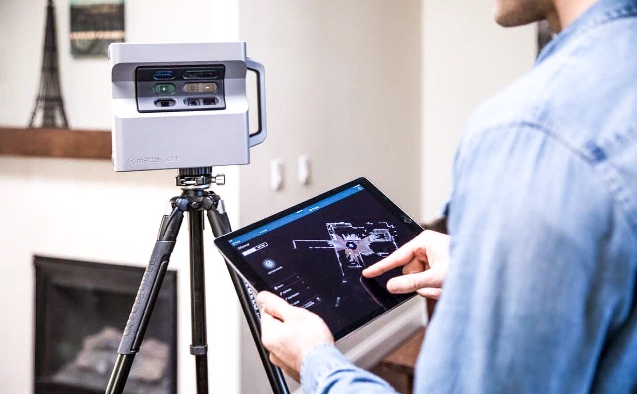 Person using tablet to control 3d room camera