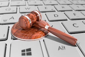 Auctioneers gavel on computer keyboard