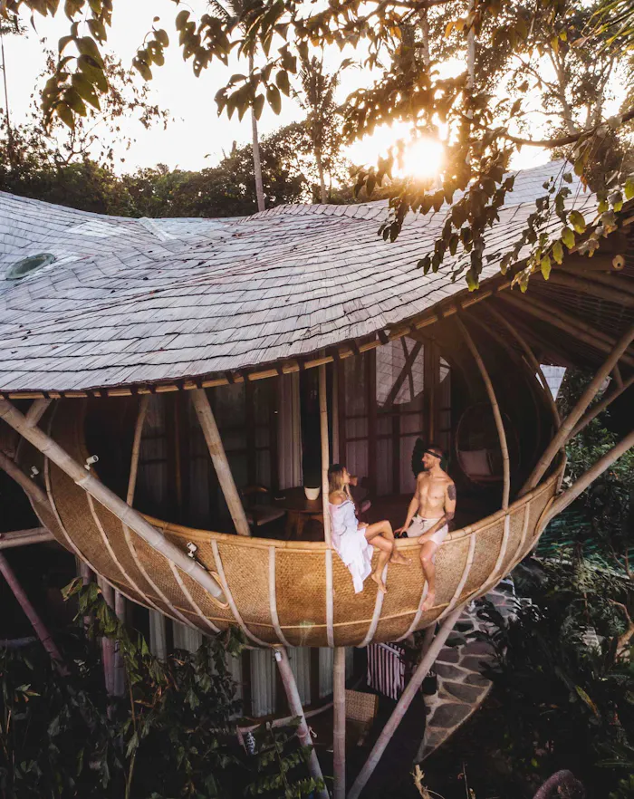 Couple sitting on the balcony of a cocoon villa at Ulaman