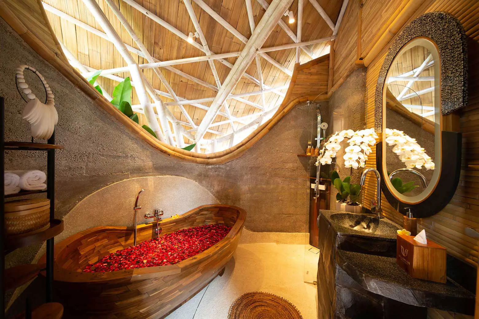 bathroom with bathtub filled with flowers in a one bedroom villa with private pool in eco luxury resort in bali