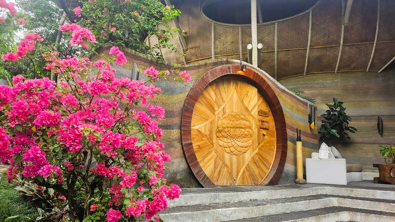 beautiful large wooden door of a eco luxury resort in bali