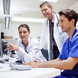 Doctors looking at display
