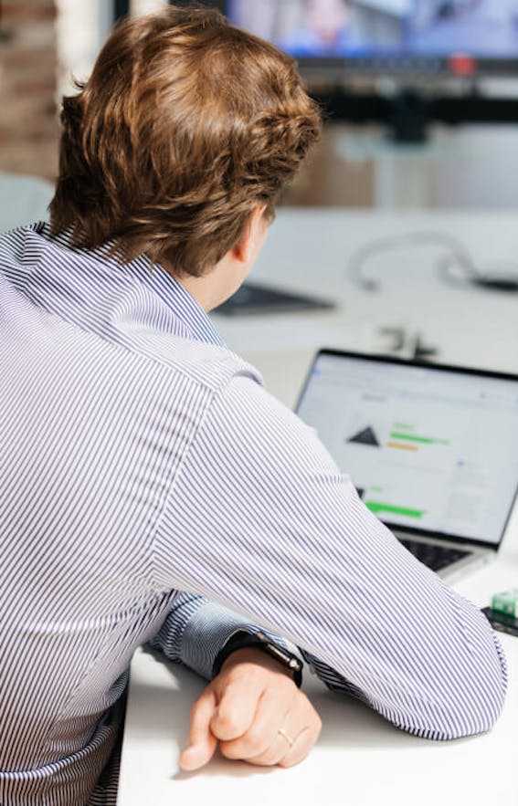 Managing Director Daniel Willman works on his laptop during a video conference.