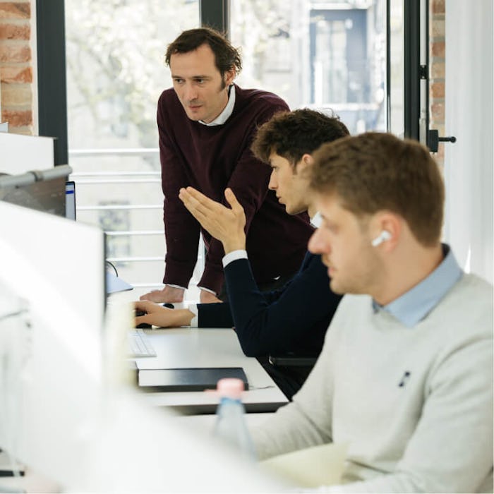 Software engineer Anton Daneyko and machine learning engineer Arne Rosenberg discuss the contents of Arne's computer screen.