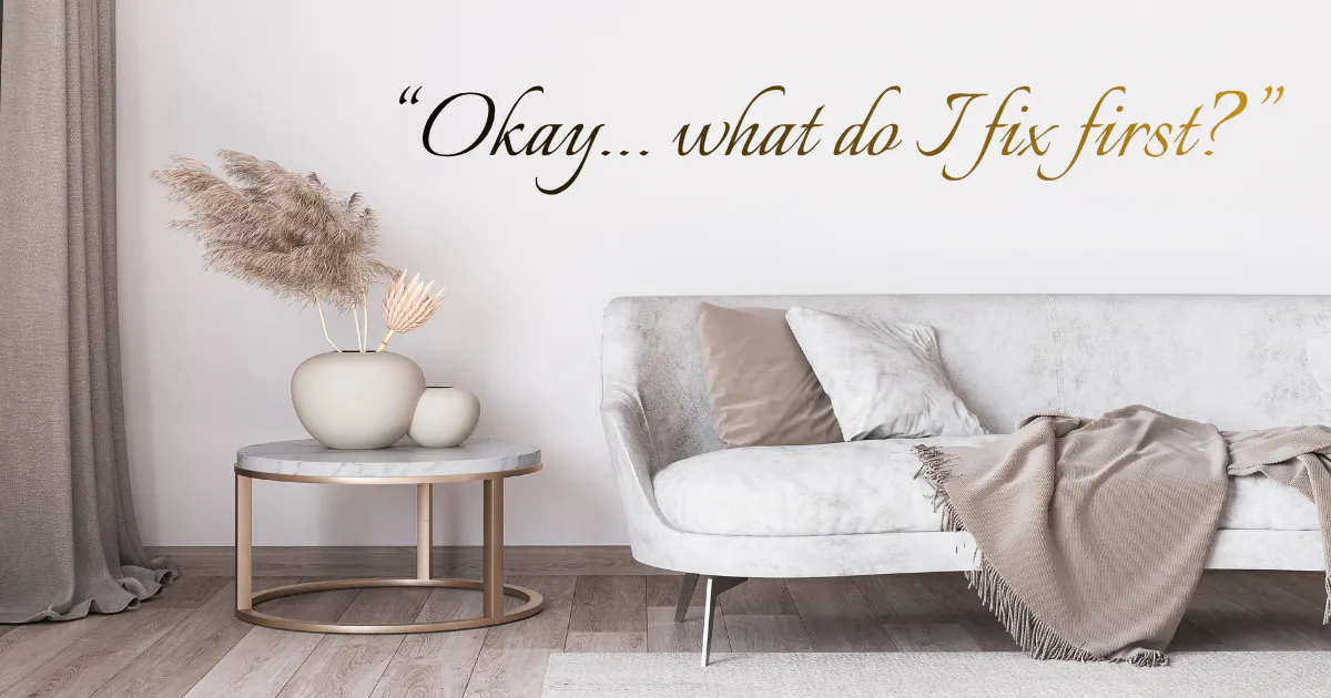 Visual of a couch and coffee table with decor all in neutral colours in a modern and stylish apartment.