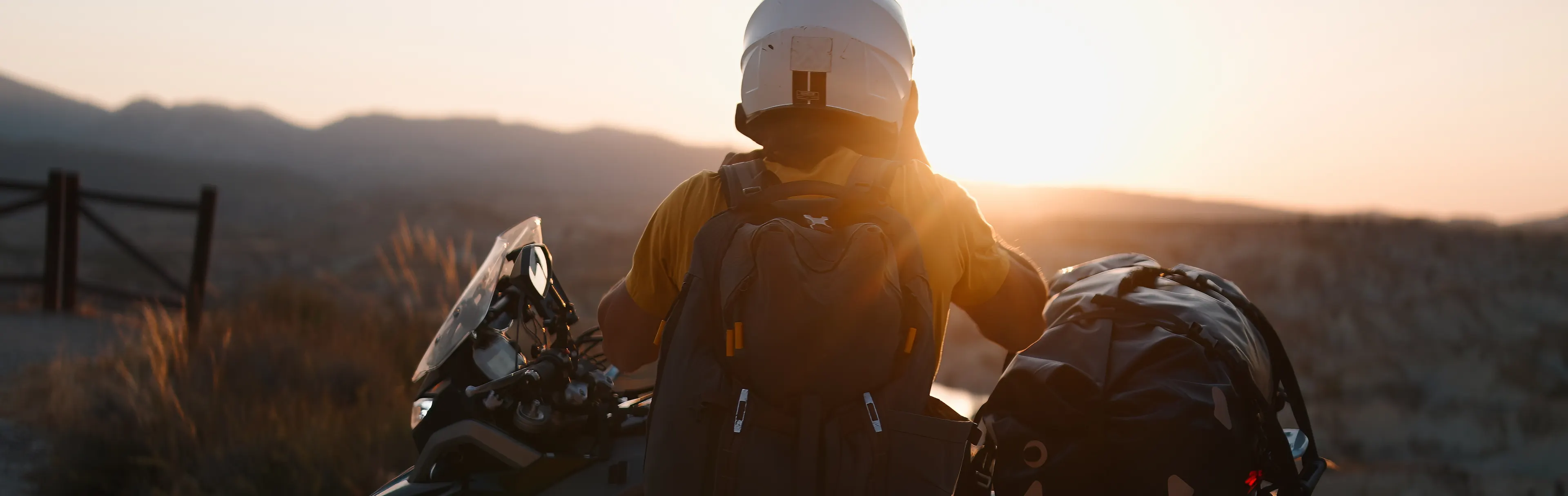 man on a motorbike road trip stopping to see the sunset