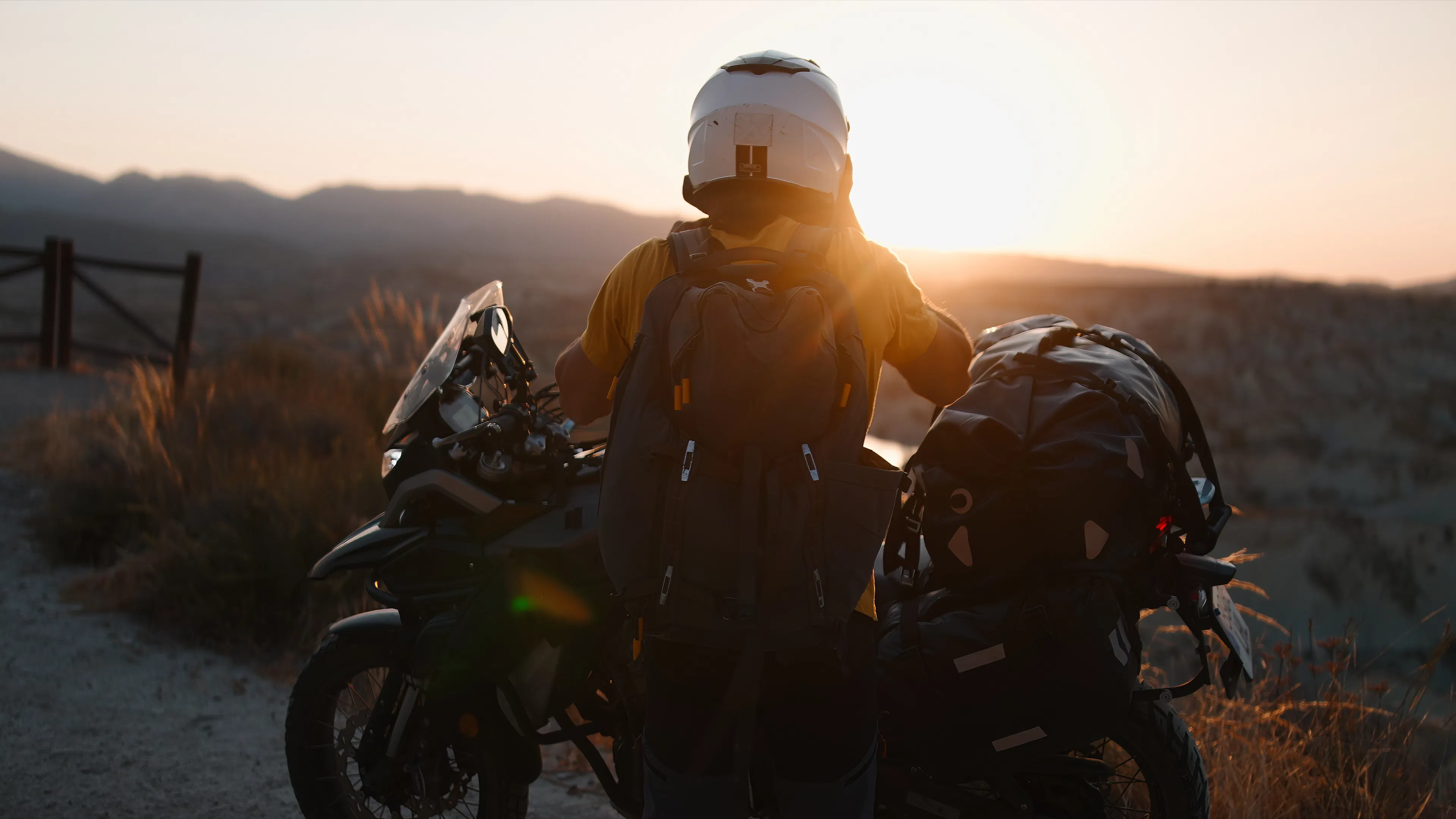 man on a motorbike road trip stopping to see the sunset