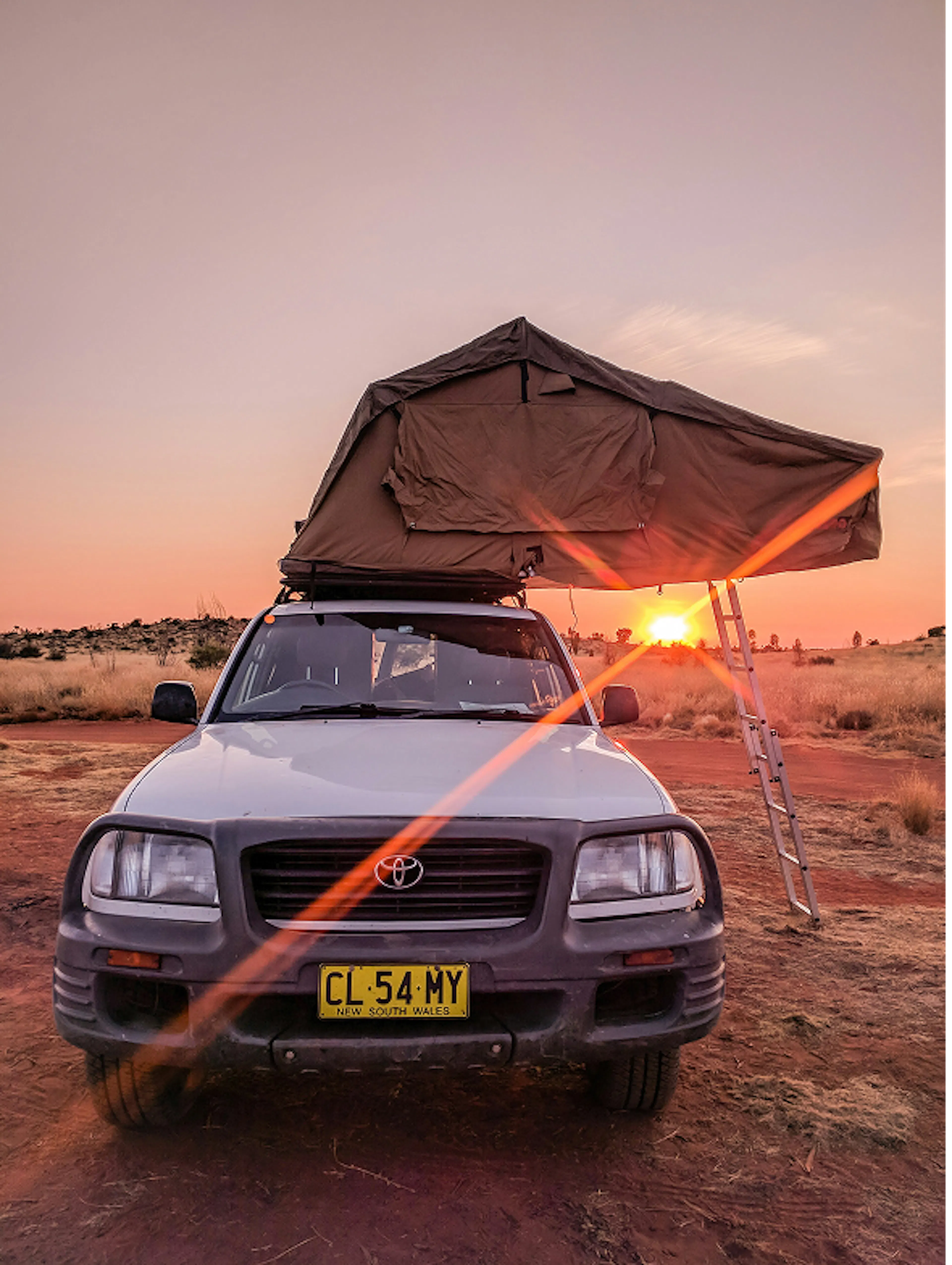 Ute with rooftop tent parked outdoors