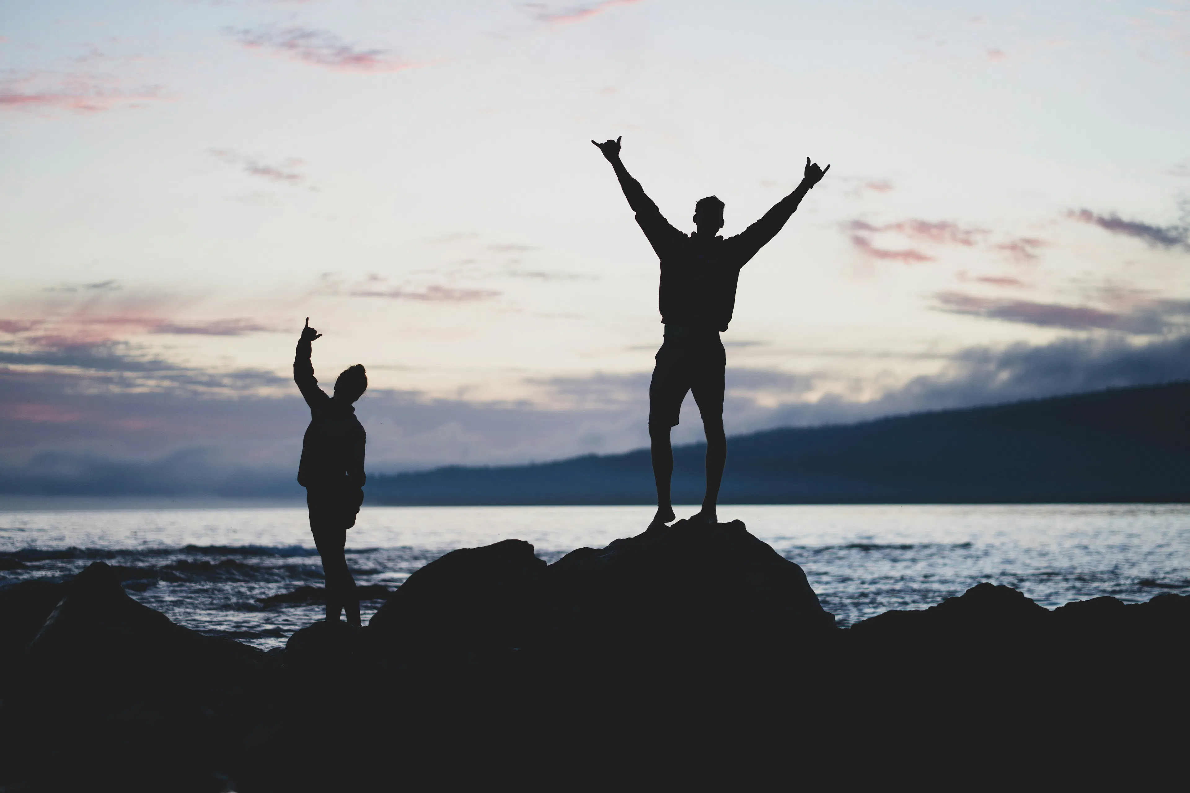 Cheerful couple at the beach during sunset