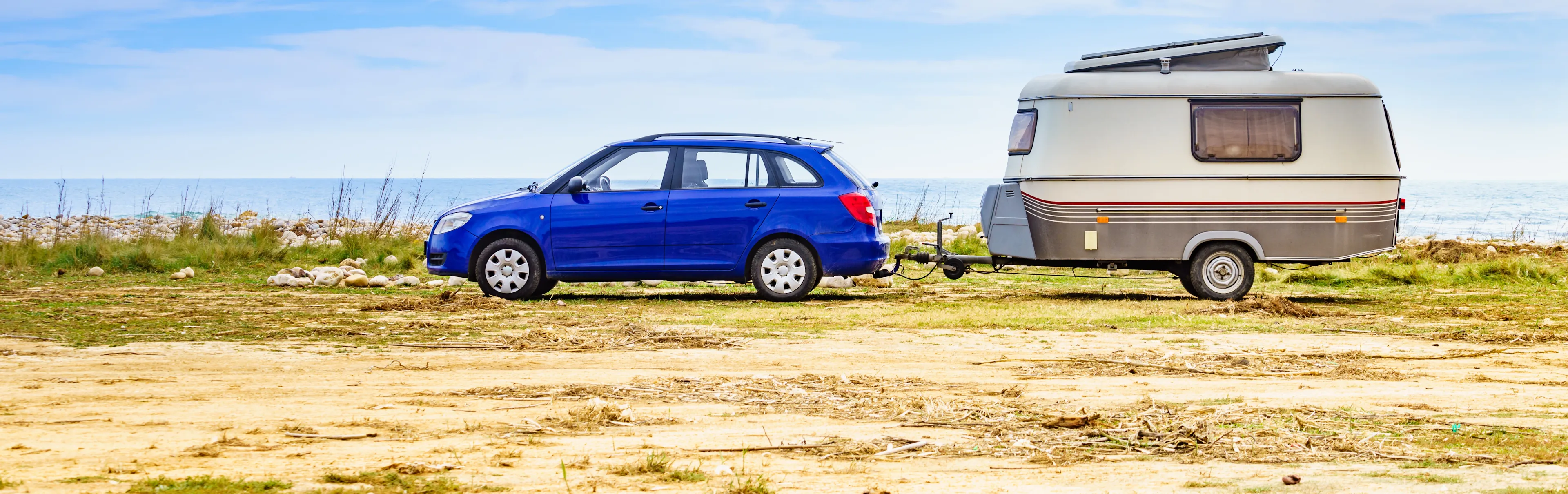 Camper trailer camping on seashore, vacation with mobile home