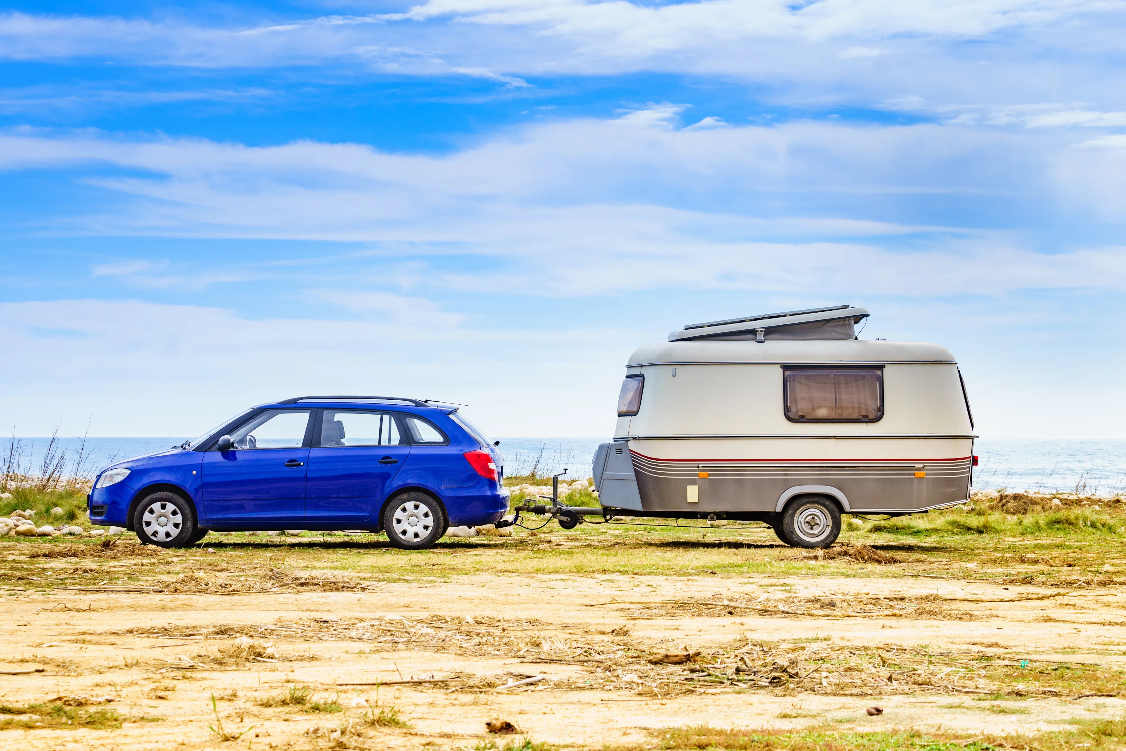 Camper trailer camping on seashore, vacation with mobile home