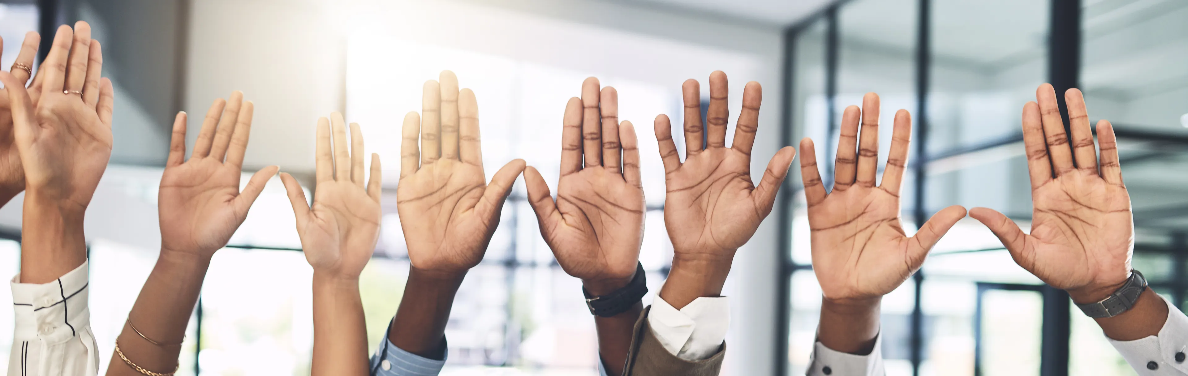 Business people, hands and question at presentation in office with volunteer, team building and attention. Collaboration, employees and vote for participation, audience and banner with FAQ for career