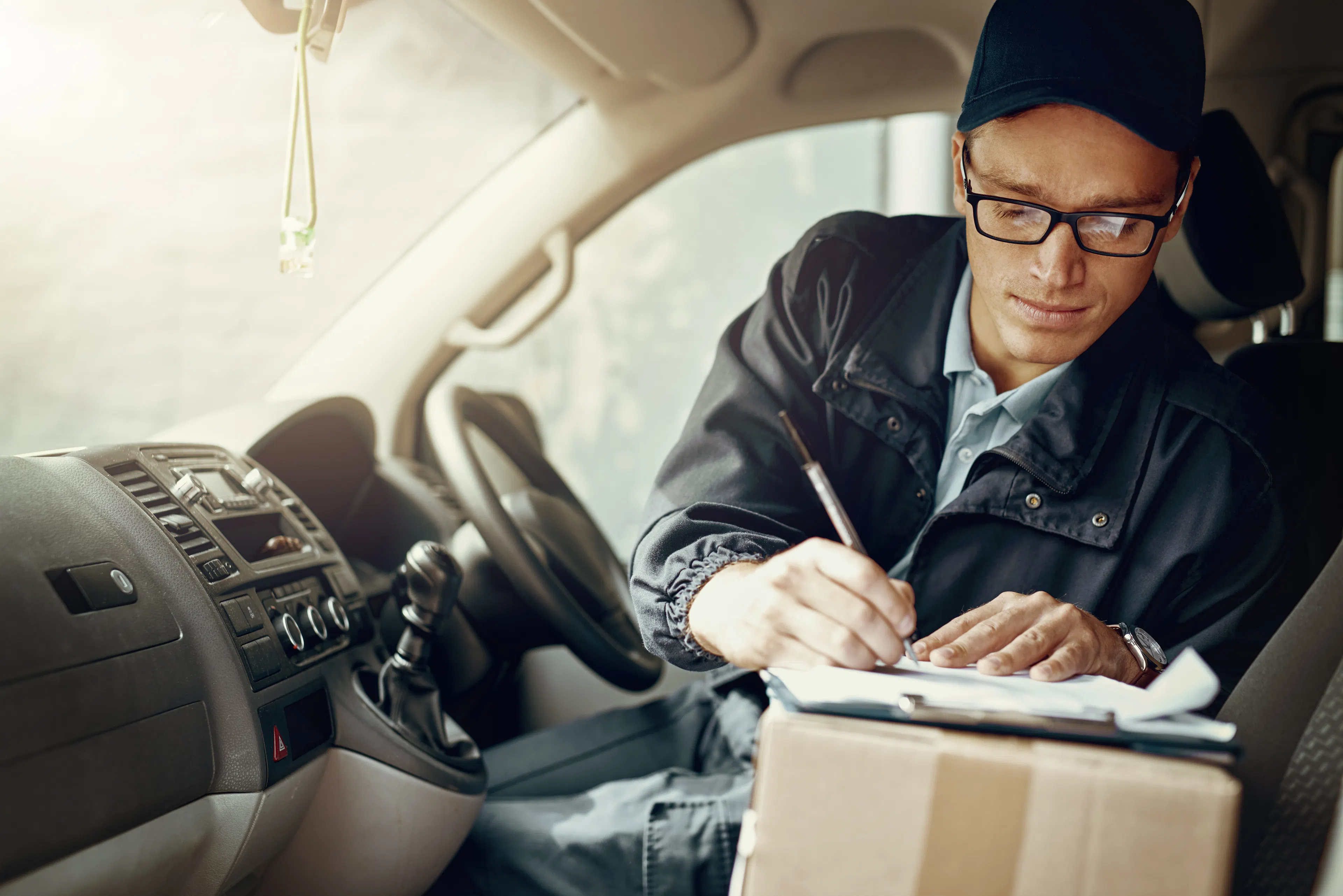 Shot of a courier making deliveries in his van
