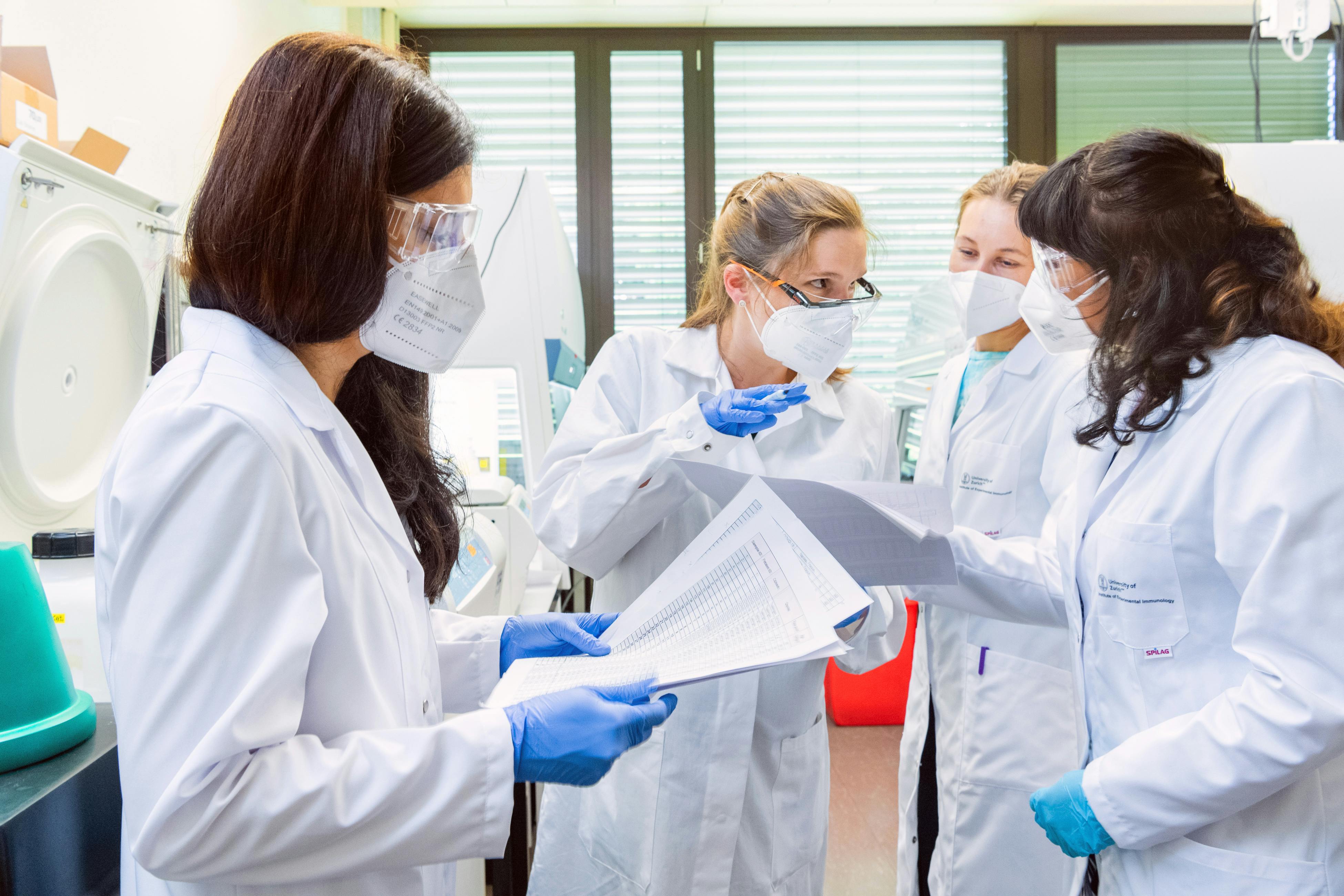 Junior researchers discussing their results at the laboratory