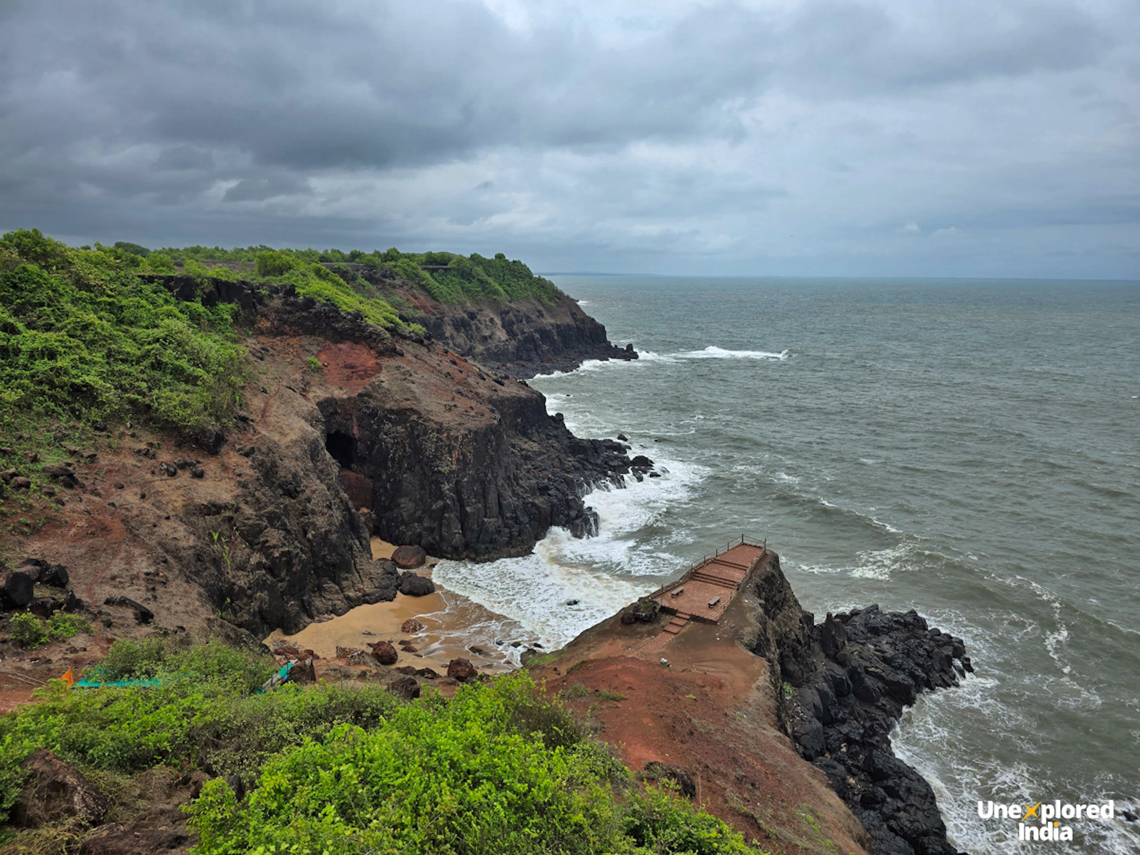 View of Kasheli Cliff on the Konkan coast, with laterite cliffs, rocky shores and waves meeting the Arabian Sea.