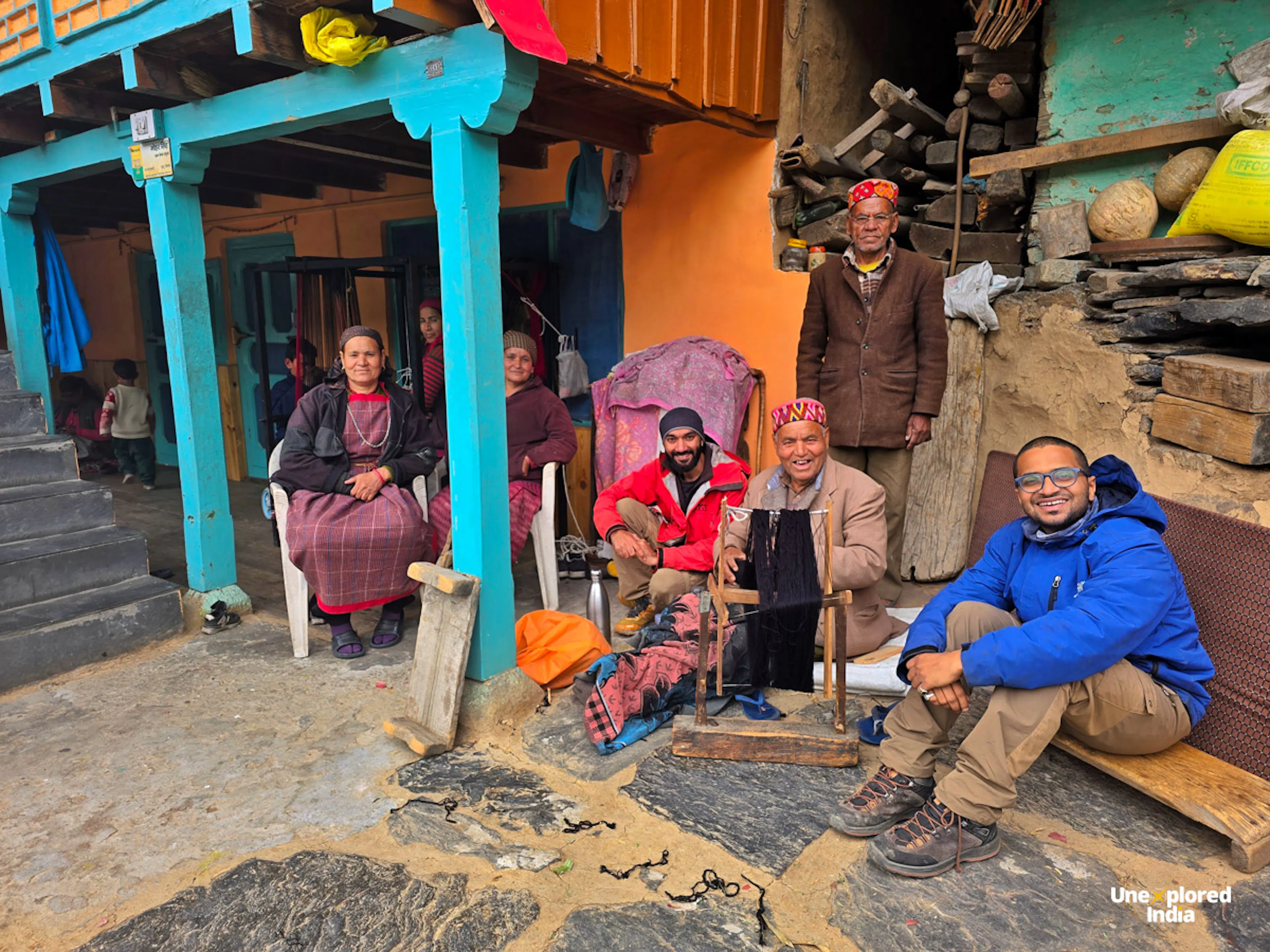 Travellers with local hosts outside a village home, Himachal Pradesh culture and homestay life