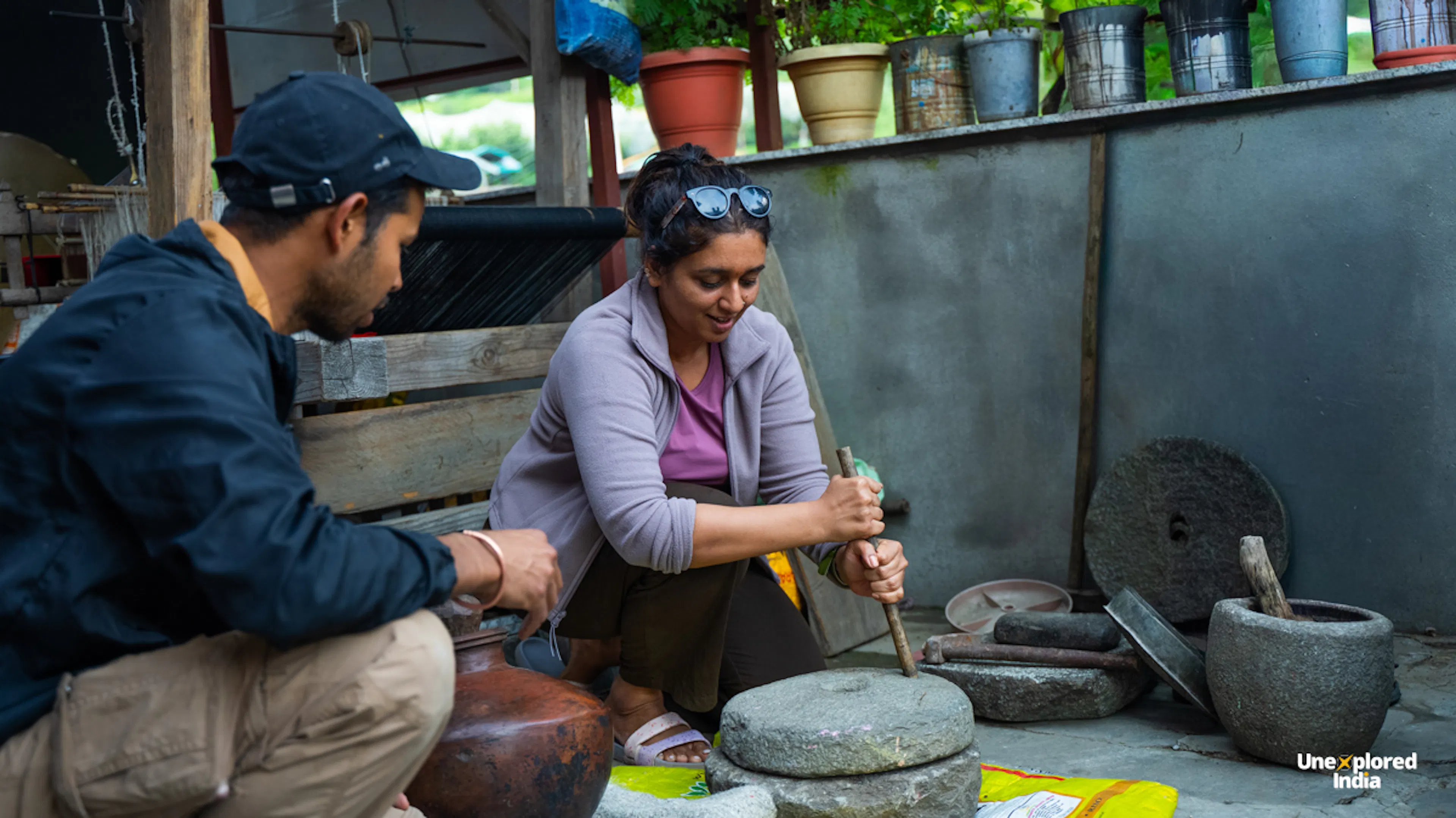 Traveller sitting with a local host in a Kathkuni kitchen, Himachal Pradesh village life