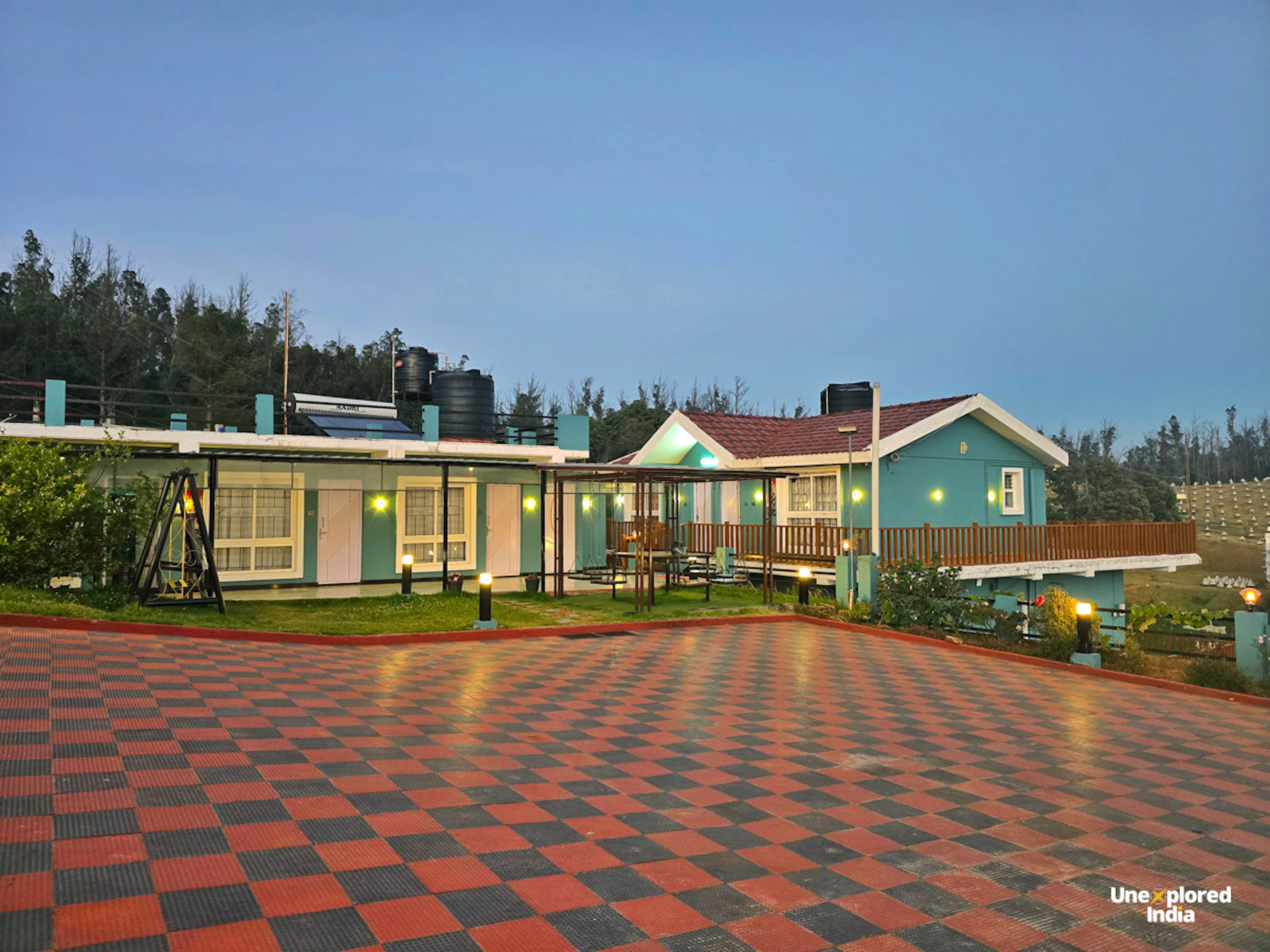 Ooty homestay surrounded by greenery in the Nilgiris, with a spacious outdoor courtyard.