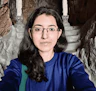 a fair spectacled woman taking a selfie