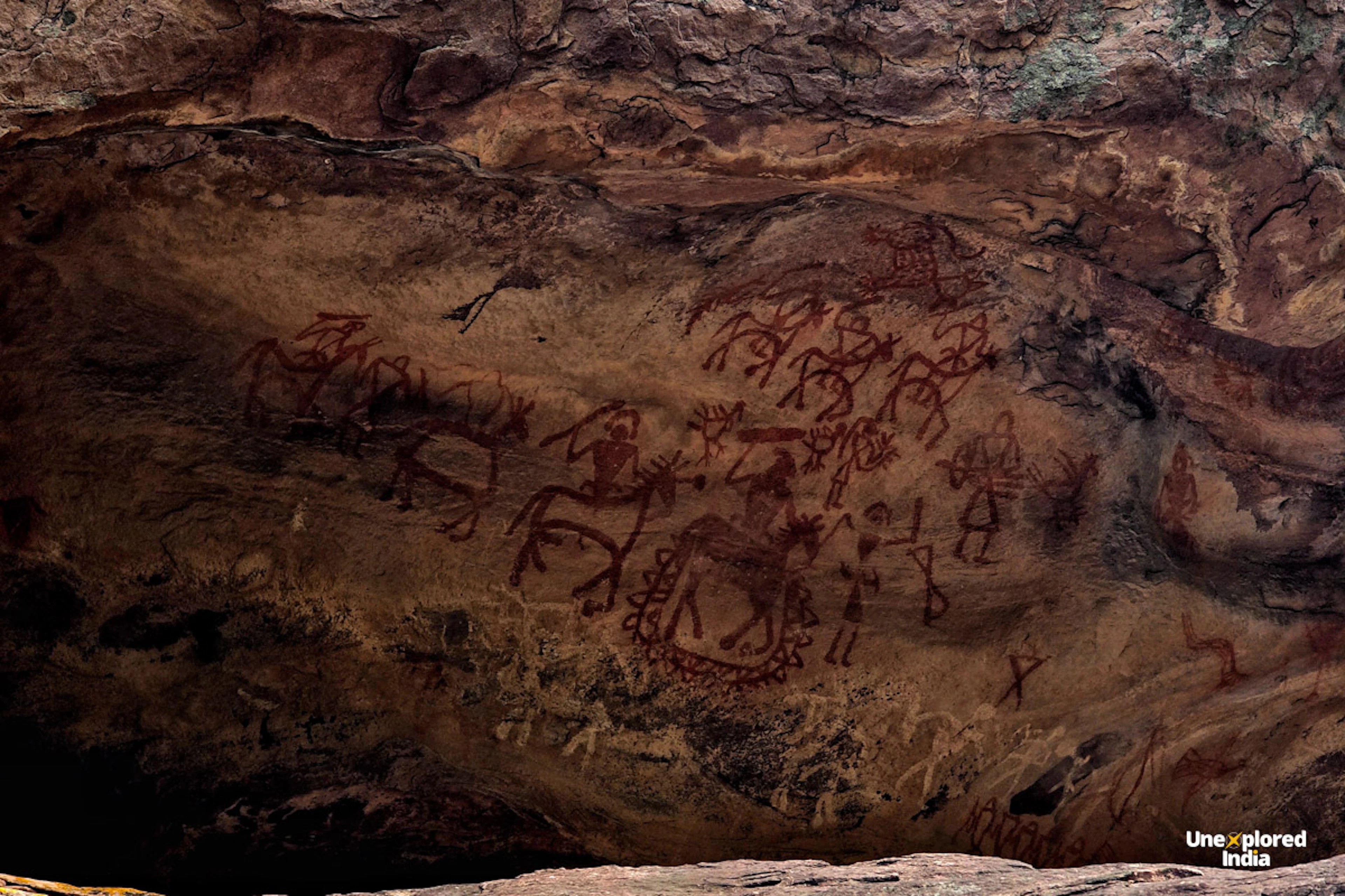 Prehistoric rock paintings depicting early human life inside the Bhimbetka Rock Shelters in Madhya Pradesh