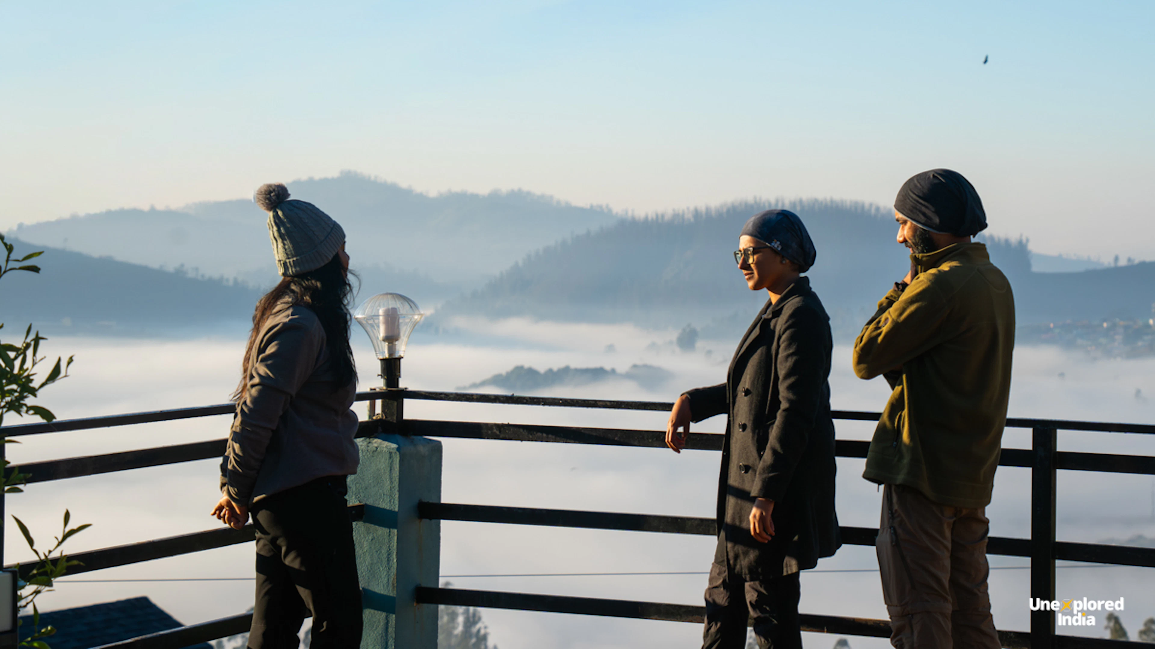 Travellers enjoying a misty mountain view from a homestay in Ooty, Nilgiris