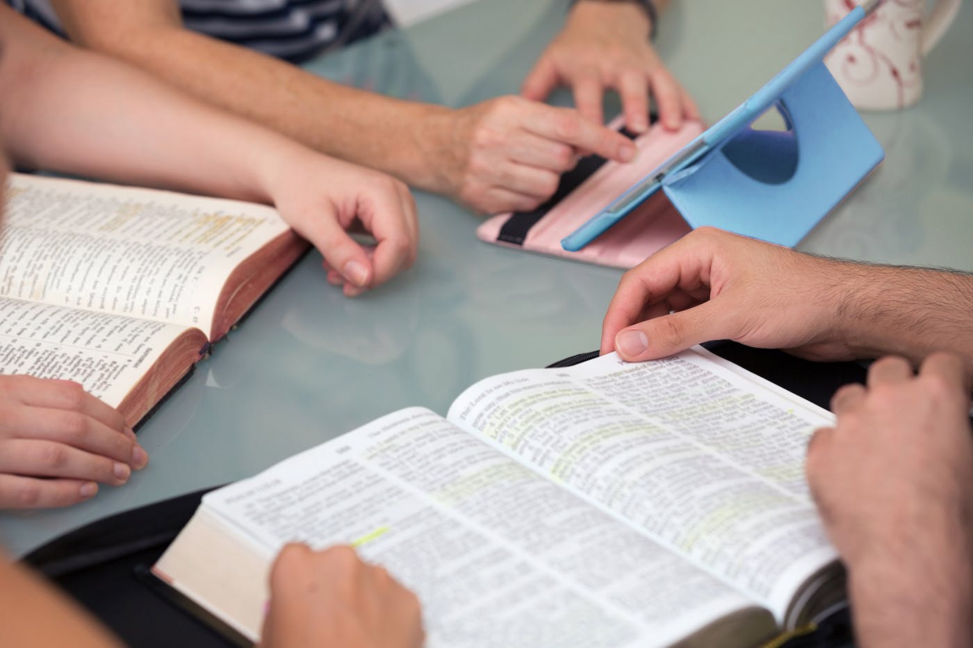 Bibles, hands, computer