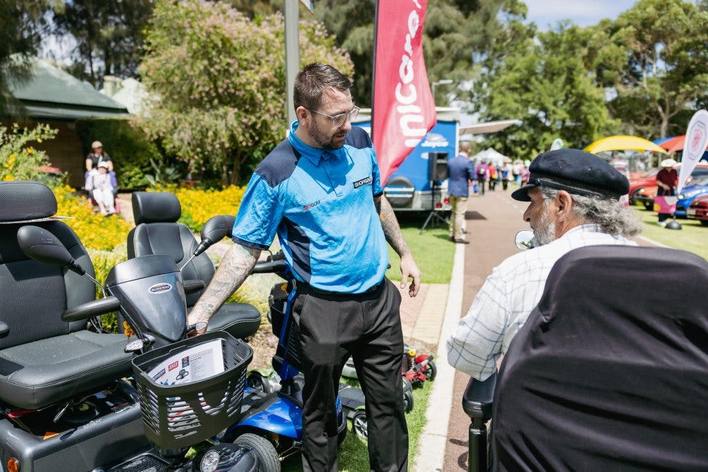 Seniors explore power scooters and wheelchairs from Shoprider and Unicare at Have A Go Day Burswood
