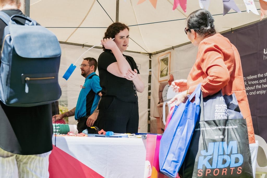 Seniors learn about bathroom aids and long handled sponges from Unicare Health