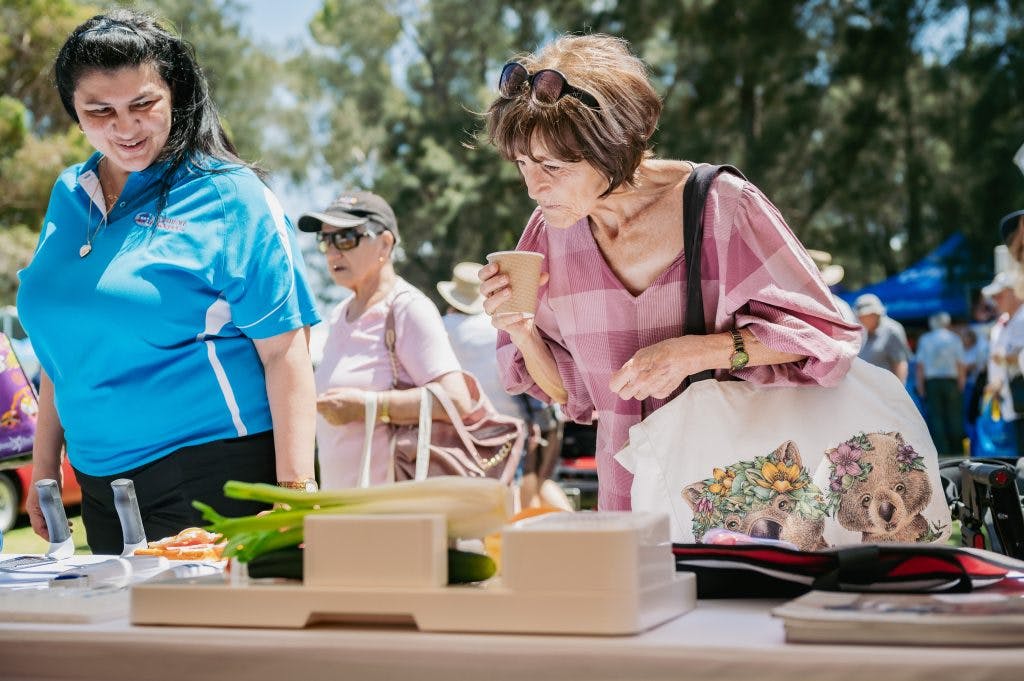 Seniors explore food preparation and kitchen aids from Unicare Health at Have A Go Day Burswood