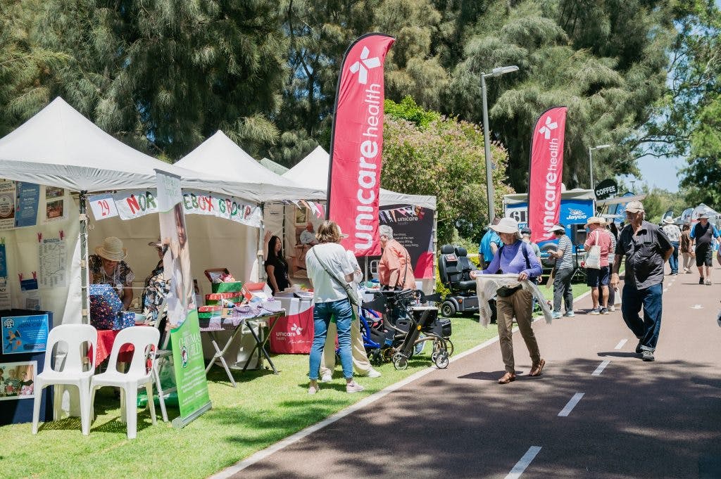 Seniors visit the Unicare Health independent living aid stand at Have A Go Day 2023