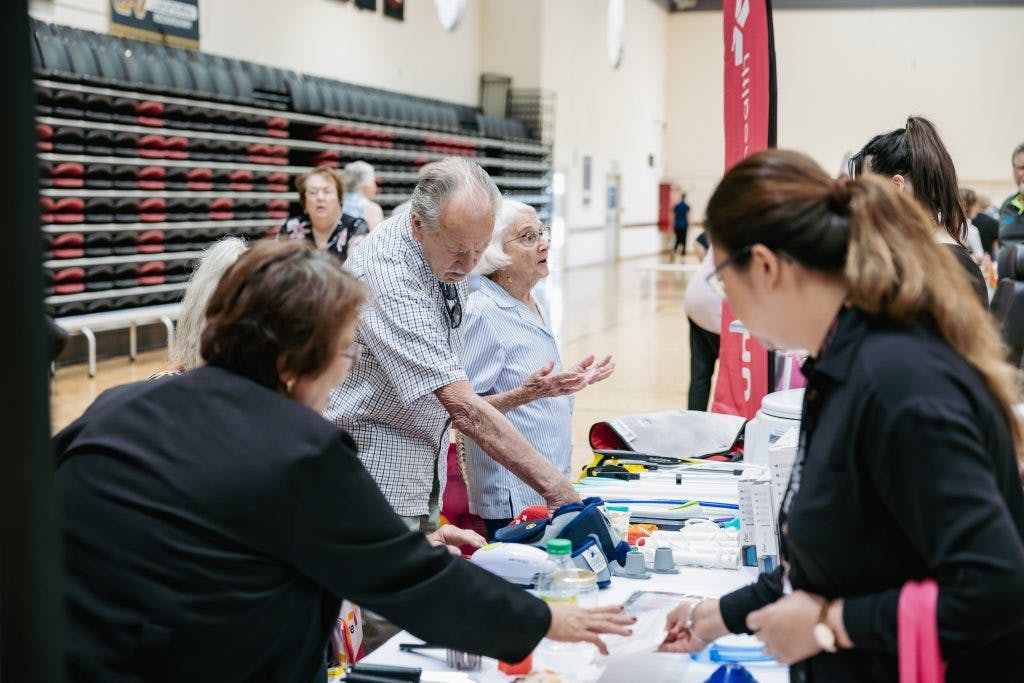 Seniors discuss daily living aids with Unicare Health at Rockingham Seniors and Carers Expo 2023