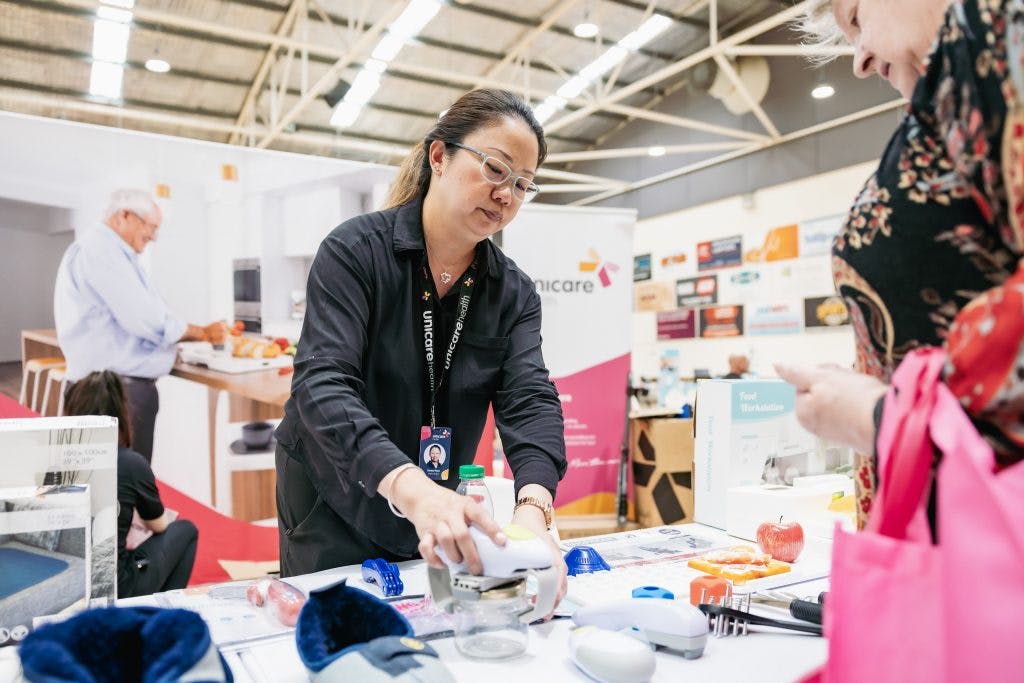 Unicare Health demonstrates One Touch kitchen aid assistive technology at Rockingham Seniors and Carers Expo
