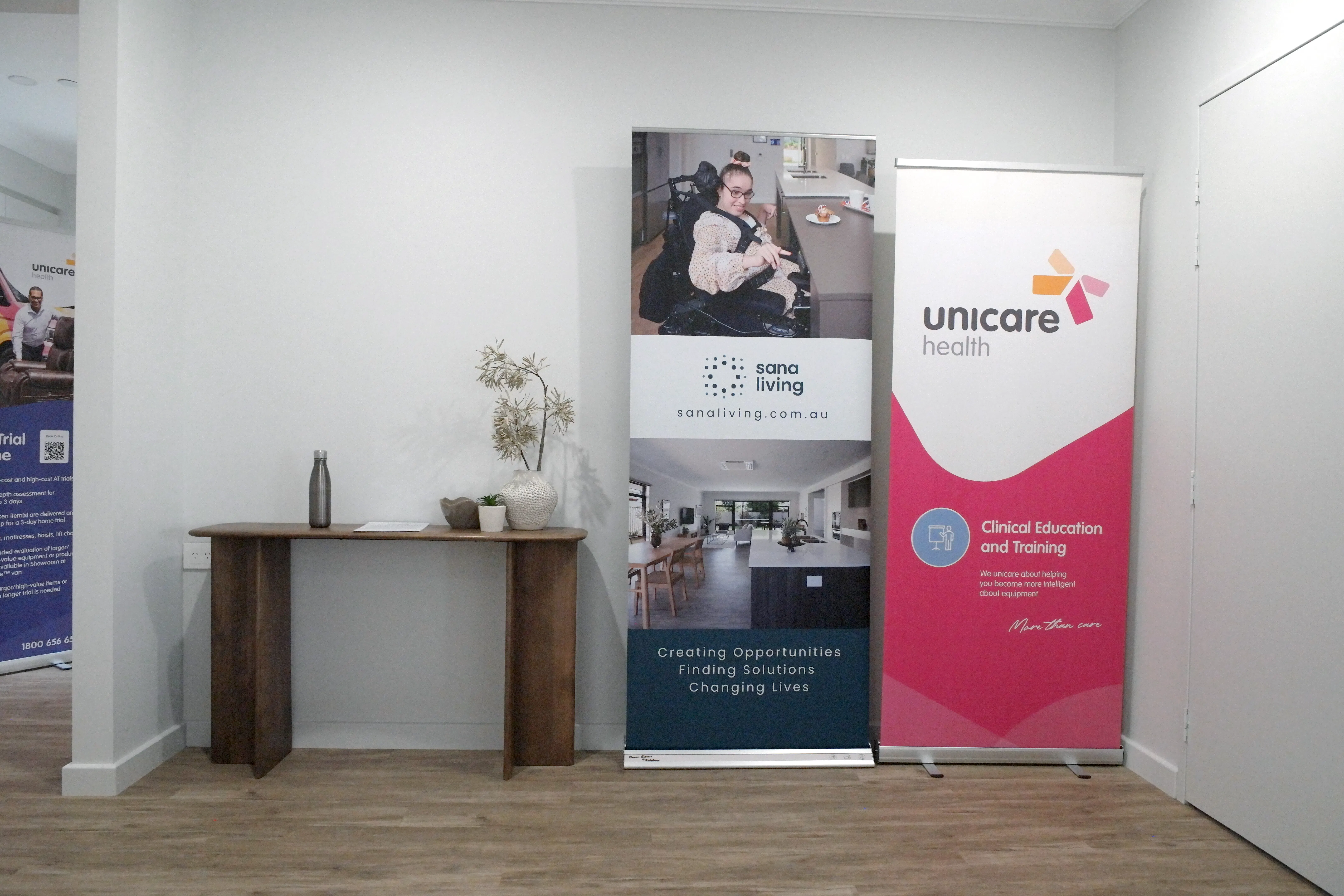 Unicare Health and Sana Living event banners displayed at a joint assistive technology education session in Atwell, Perth.