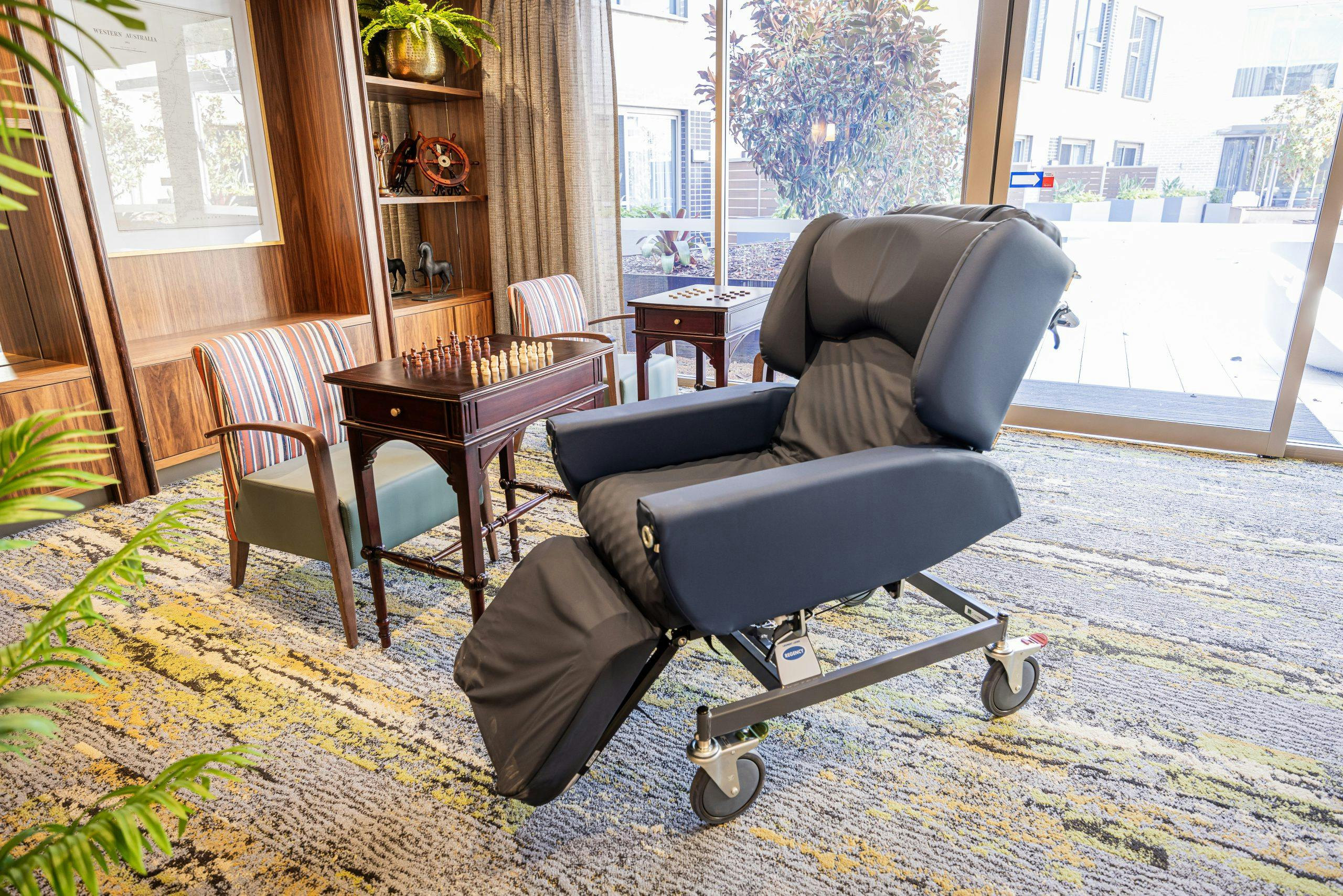 Middle Swan Residential Care regency recliner chair next to a chess board