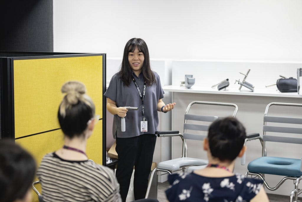 A Unicare Health clinical trainer demonstrates JUVOCare shower commodes at the Unicare Health free masterclass for occupational therapists