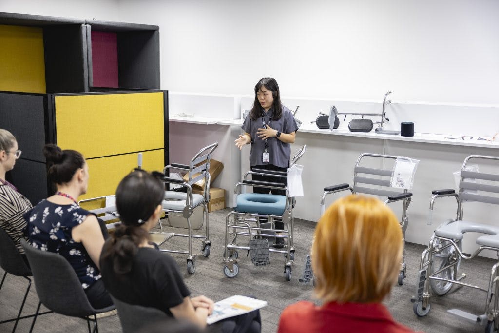 Occupational therapists ask a clinical trainer questions about JUVOCare shower commodes in the Unicare Health Assistive Technology Collaboration Centre